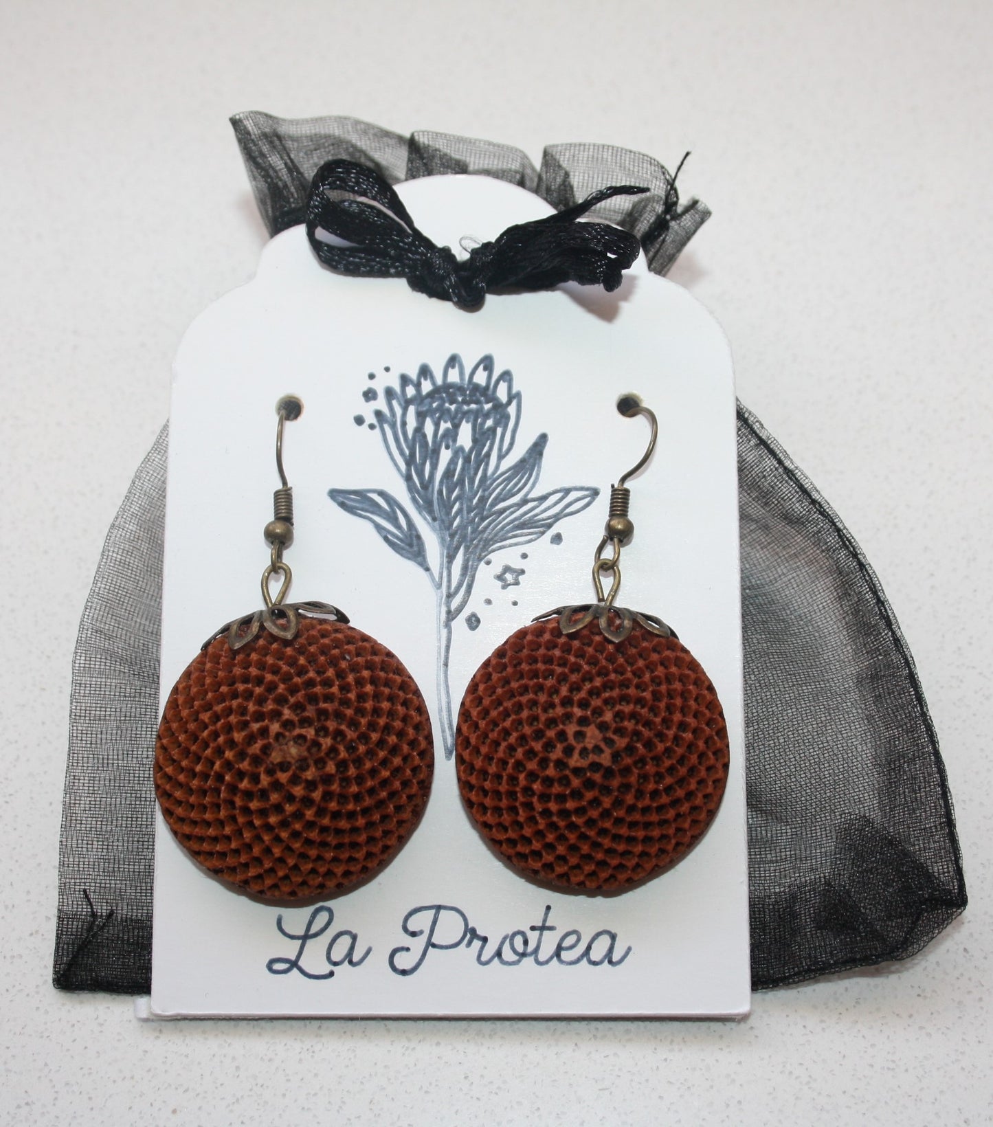 Protea seedpod earrings with chiffon bag