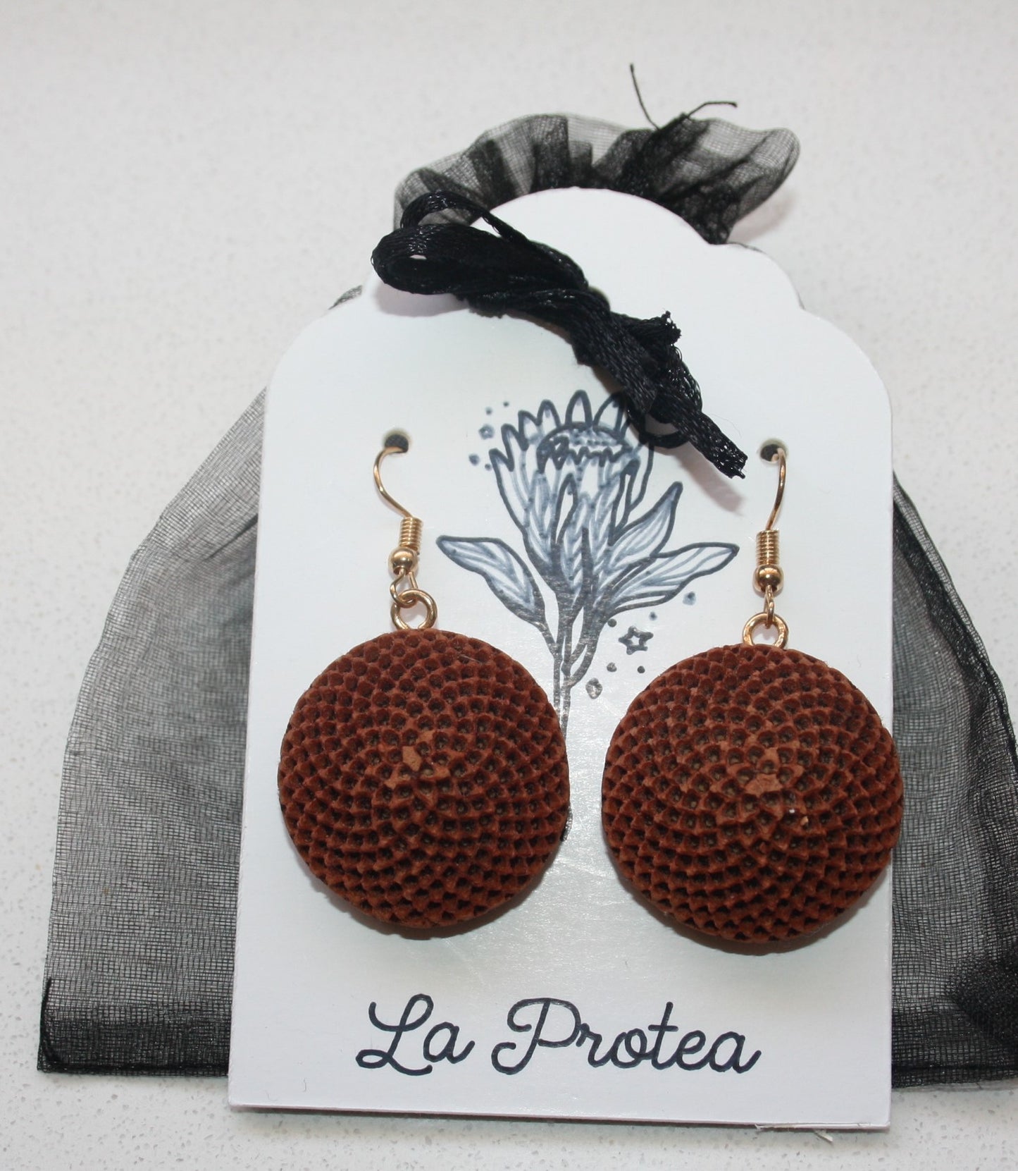 Protea seedpod earrings with chiffon bag