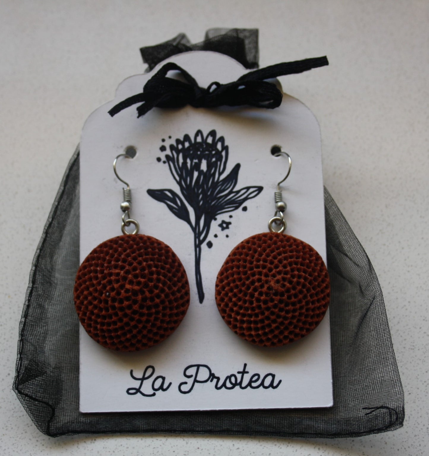 Protea seedpod earrings with chiffon bag